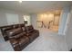 Spacious loft area with a comfortable reclining sofa, and neutral decor at 3052 Living Coral Dr, Odessa, FL 33556