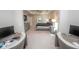 Spacious main bedroom with carpeting, neutral decor, and a glimpse into a separate office area at 3052 Living Coral Dr, Odessa, FL 33556