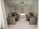 Bright office space featuring a ceiling fan, natural light, and two modern workstations at 3052 Living Coral Dr, Odessa, FL 33556
