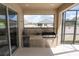 Covered outdoor kitchen has a grill, mini-fridge, and stone accents, ideal for entertaining next to the pool at 3052 Living Coral Dr, Odessa, FL 33556
