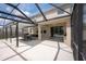 Spacious screened-in patio features an outdoor kitchen, dining area, and seamless access to the refreshing pool at 3052 Living Coral Dr, Odessa, FL 33556