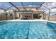 Beautifully designed, screened-in pool and spa area offer ultimate relaxation, complemented by an outdoor entertainment space at 3052 Living Coral Dr, Odessa, FL 33556