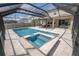 Stunning, screened-in pool and spa area offers a relaxing oasis with a spacious travertine deck at 3052 Living Coral Dr, Odessa, FL 33556