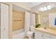 Cozy bathroom with tiled shower and tub, vanity, and patterned accent wall at 3602 Pine Knot Dr # 0, Valrico, FL 33596