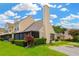 Townhouse exterior featuring a screened-in porch, manicured lawn, and dedicated parking spaces at 3602 Pine Knot Dr # 0, Valrico, FL 33596
