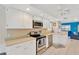 Modern kitchen featuring white cabinetry, stainless appliances, and an open layout with bright blue walls at 3602 Pine Knot Dr # 0, Valrico, FL 33596