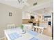 Dining area adjacent to kitchen features a vaulted ceiling, ample lighting, and stylish decor at 3602 Pine Knot Dr # 0, Valrico, FL 33596
