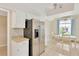 Kitchen with stainless steel refrigerator and a dining area with a view of the outdoors at 3602 Pine Knot Dr # 0, Valrico, FL 33596