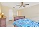 Bedroom with neutral walls, dark wood furniture, and a patterned blue bedspread at 3602 Pine Knot Dr # 0, Valrico, FL 33596