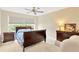 Bright bedroom with a large window, neutral walls, and dark wood furniture at 3602 Pine Knot Dr # 0, Valrico, FL 33596
