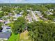 Expansive aerial view of neighborhood with tree lined streets near a pond on a sunny day at 3809 N 14Th St, Tampa, FL 33603