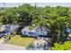 Charming home with cozy front porch, framed by mature trees, offering a serene and picturesque setting at 3809 N 14Th St, Tampa, FL 33603