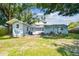 Spacious backyard with patio area, lush lawn, and mature trees offering shade at 3809 N 14Th St, Tampa, FL 33603