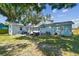 Exterior of home showcasing a spacious backyard with patio and lush lawn at 3809 N 14Th St, Tampa, FL 33603