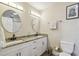 Bathroom with double sinks, granite countertop, modern fixtures, and decorative mirrors at 3809 N 14Th St, Tampa, FL 33603