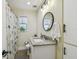 Bathroom featuring vanity sink, modern faucet, decorative mirror, and shower with curtain at 3809 N 14Th St, Tampa, FL 33603