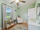 Bedroom with mint green walls, white furniture, and ceiling fan at 3809 N 14Th St, Tampa, FL 33603