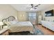 Bright bedroom with a comfortable bed, natural light, and a dresser with a large mirror at 3809 N 14Th St, Tampa, FL 33603