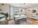 Light-filled dining room featuring wood floors and a large window with neighborhood views at 3809 N 14Th St, Tampa, FL 33603