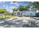 Exterior view of a cozy home with a front porch, a well-kept lawn, and a fenced yard at 3809 N 14Th St, Tampa, FL 33603