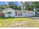 Charming single-story home featuring a front porch with chairs and a well-maintained lawn at 3809 N 14Th St, Tampa, FL 33603