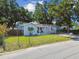 Charming single-story home with a well-maintained lawn, mature trees, and a welcoming front porch at 3809 N 14Th St, Tampa, FL 33603
