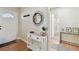 Inviting hallway with console table, mirror, and access to the front door and bathroom at 3809 N 14Th St, Tampa, FL 33603