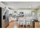 Bright kitchen boasts white cabinets, stainless steel appliances, and an island with bar seating at 3809 N 14Th St, Tampa, FL 33603