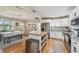 Modern kitchen with stainless steel appliances, light cabinets, and a breakfast table adjacent to dining room at 3809 N 14Th St, Tampa, FL 33603