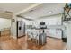 Well-lit kitchen with stainless steel appliances, white cabinetry, and a center island with seating at 3809 N 14Th St, Tampa, FL 33603