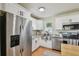 The updated Kitchen features stainless steel appliances, granite countertops, and light cabinets at 3809 N 14Th St, Tampa, FL 33603