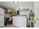 Laundry area featuring a washer, dryer and water heater in a brightly lit space at 3809 N 14Th St, Tampa, FL 33603