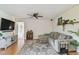 Comfortable living room featuring a large sectional sofa, modern entertainment center, and ceiling fan at 3809 N 14Th St, Tampa, FL 33603