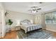 Cozy bedroom with hardwood floors, ceiling fan, large window, and a neutral color scheme at 3809 N 14Th St, Tampa, FL 33603