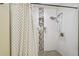 Modern shower with white tile, built-in niche, rainfall showerhead, and decorative accent tiles at 3809 N 14Th St, Tampa, FL 33603