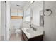 Clean bathroom with single sink vanity, toilet and large mirror, and built-in cabinet at 3901 17Th N Ave, St Petersburg, FL 33713