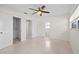 Bright bedroom featuring a ceiling fan, closet, and neutral walls at 3901 17Th N Ave, St Petersburg, FL 33713