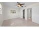 Bright bedroom featuring a ceiling fan, closet, and neutral walls at 3901 17Th N Ave, St Petersburg, FL 33713