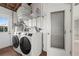 Laundry room area featuring side-by-side washer and dryer, shelving, and a utility sink at 3901 17Th N Ave, St Petersburg, FL 33713