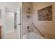 Bathroom featuring a shower with tiled walls and a convenient built-in shelf at 3901 17Th N Ave, St Petersburg, FL 33713