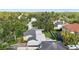 Aerial view of the backyard, showcasing the patio and playground surrounded by lush greenery at 4111 W Granada St, Tampa, FL 33629
