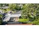 An aerial view shows a charming home with mature trees, a patio, and a well-maintained backyard at 4111 W Granada St, Tampa, FL 33629