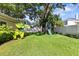 Expansive backyard featuring lush grass, mature trees, and a playset, ideal for Gathering fun at 4111 W Granada St, Tampa, FL 33629