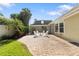 Backyard patio features four white Adirondack chairs surrounding a small white table at 4111 W Granada St, Tampa, FL 33629