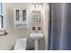 Bathroom featuring a pedestal sink, vanity, and tiled shower, providing a clean and functional space at 4111 W Granada St, Tampa, FL 33629