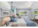 Bright bedroom featuring natural light, hardwood floors, and coastal decor at 4111 W Granada St, Tampa, FL 33629