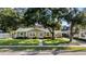 Charming single-story home with a lush green lawn, beautiful landscaping, and inviting entrance at 4111 W Granada St, Tampa, FL 33629
