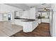 Well-lit kitchen featuring white cabinets, granite counters, and hardwood flooring at 4111 W Granada St, Tampa, FL 33629