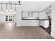 Open concept living space with granite counters and modern track lighting at 4111 W Granada St, Tampa, FL 33629