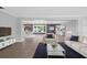 An open-concept living space with tile floors, neutral furnishings and a brick accent wall at 4111 W Granada St, Tampa, FL 33629